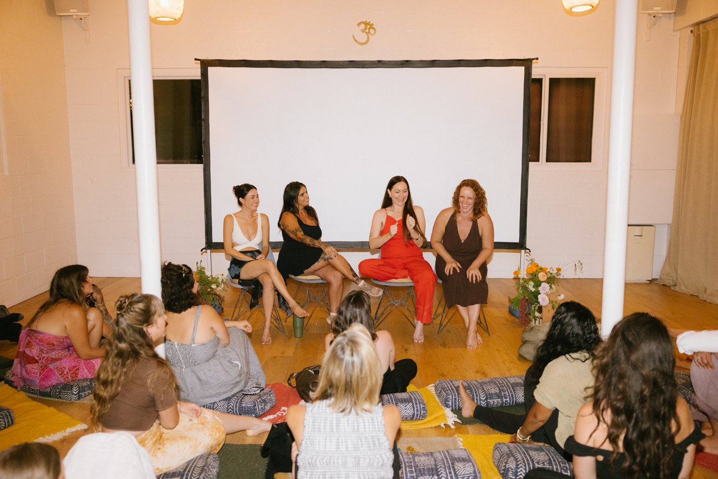 A panel conversation in front of a seated audience